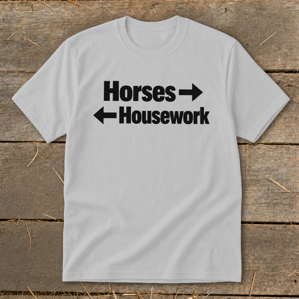 A light gray crewneck t-shirt featuring the black text Horses with a right-pointing arrow and Housework with a left-pointing arrow.