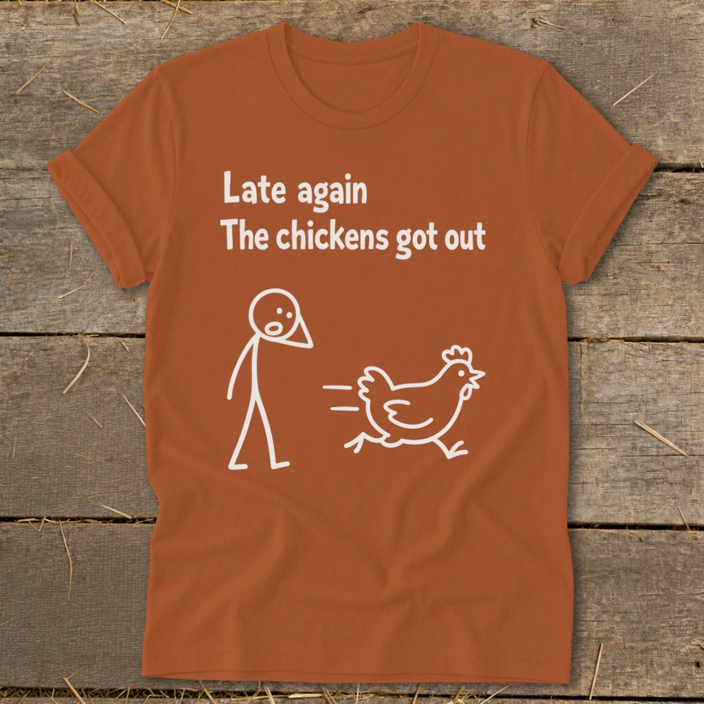 Orange t-shirt with white text "Late again The chickens got out" and stick figure graphics.