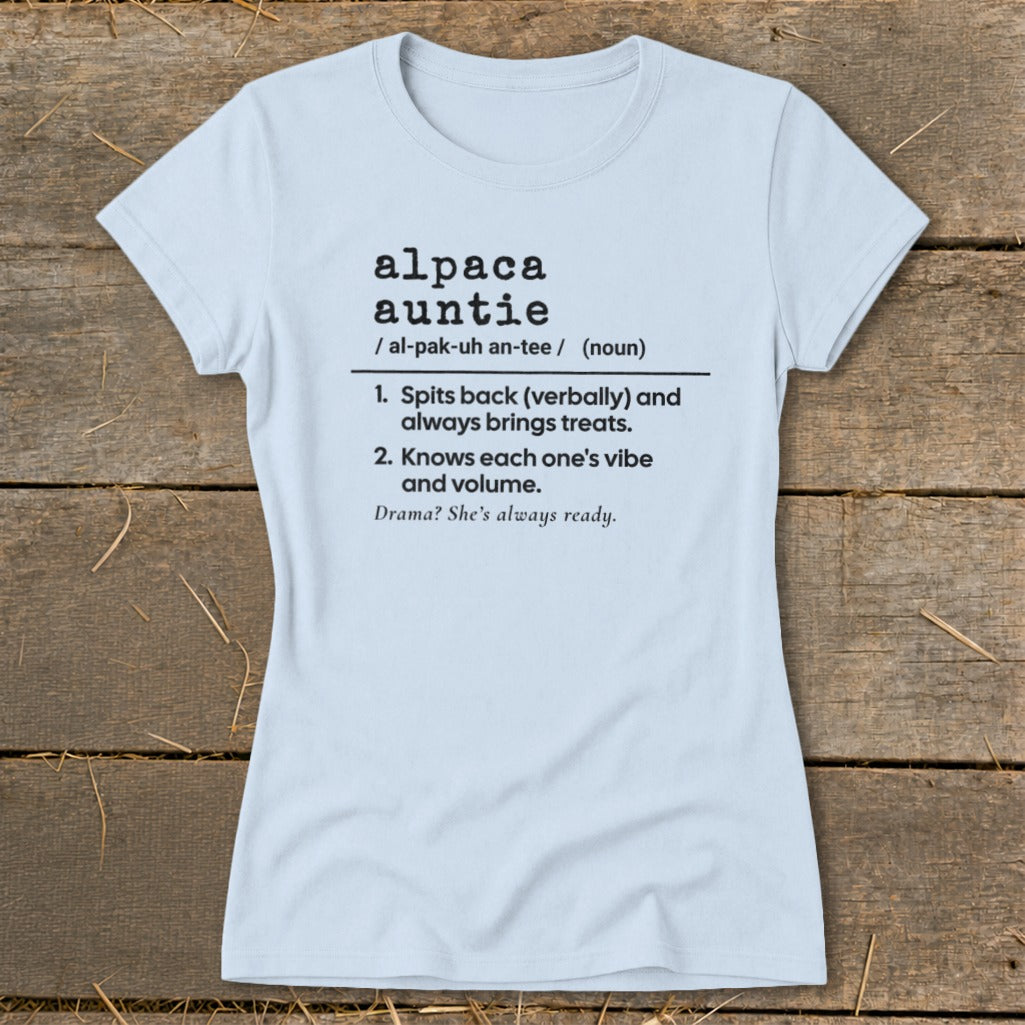 Light blue t-shirt with "alpaca auntie" definition and descriptive phrases.