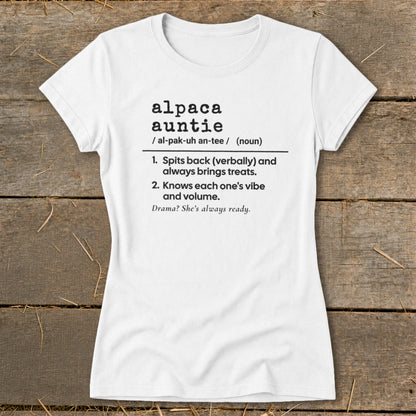 White t-shirt with black text defining "alpaca auntie" and its characteristics.