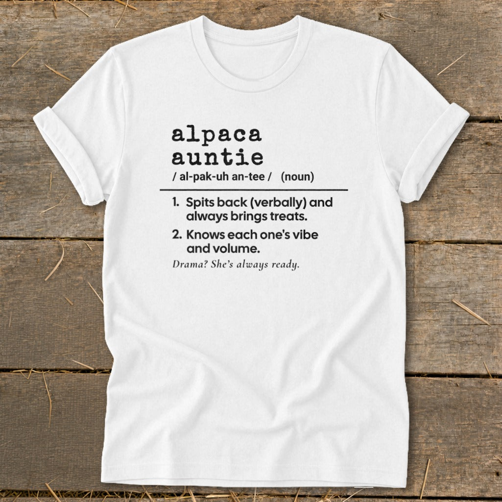 White t-shirt with black text defining "alpaca auntie" with humorous traits.