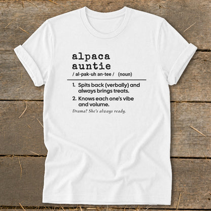 White t-shirt with black text defining "alpaca auntie" with humorous traits.