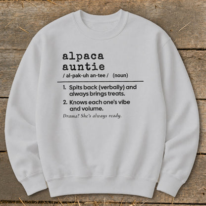White sweatshirt with black text defining "alpaca auntie" and her characteristics.