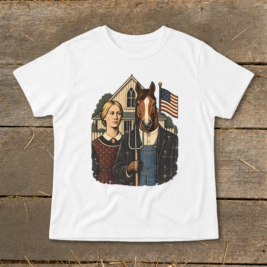 A white short-sleeve t-shirt features a satirical American Gothic illustration with a horse holding a pitchfork beside a woman.