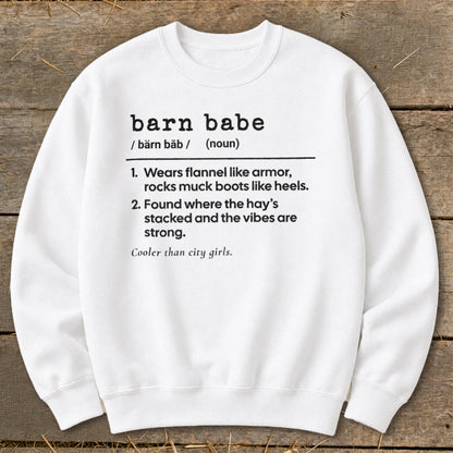 White sweatshirt with "barn babe" definition: "Wears flannel like armor, rocks muck boots like heels. Found where the hay's stacked."