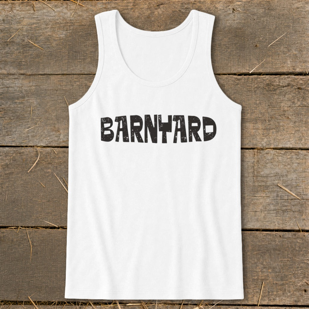 White tank top with the word "BARNYARD" printed in black, displayed flat on a wooden surface.