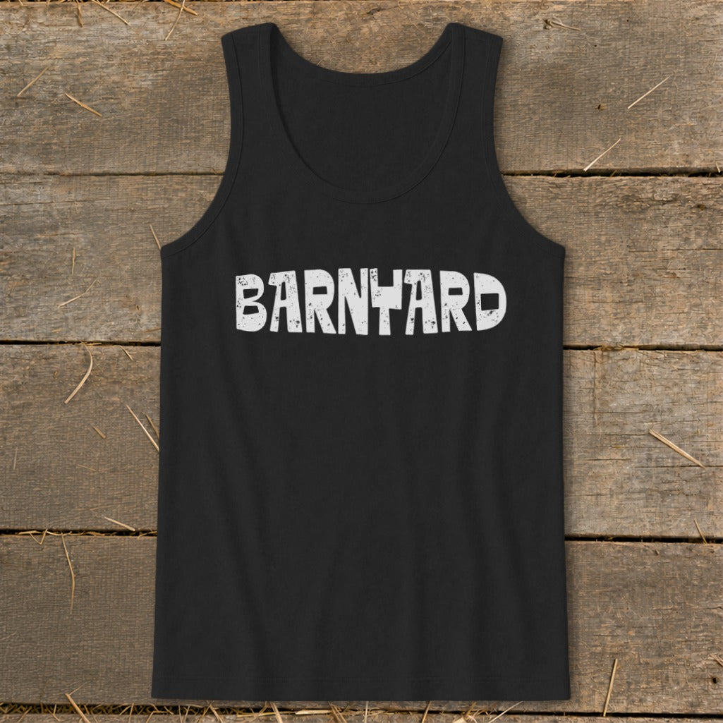 Black tank top featuring the white distressed text BARNYARD laid flat on a rustic wooden background.