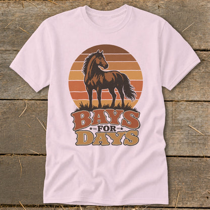 A light pink t-shirt featuring a brown horse graphic over a sunset and the text "BAYS FOR DAYS."