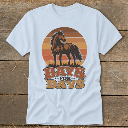 A light blue t-shirt featuring a retro graphic of a brown horse against a striped sunset and the text "Bays for Days."