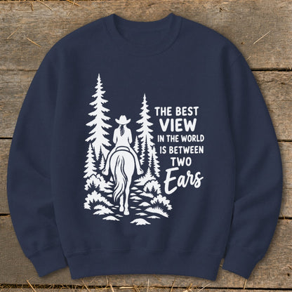 Dark blue crewneck sweatshirt featuring a white graphic of a horseback rider amid pine trees with text.