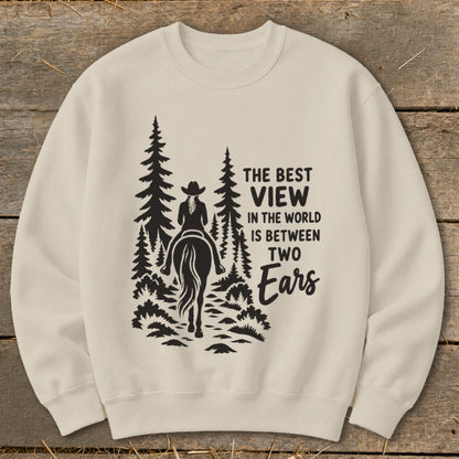 Beige crewneck sweatshirt featuring a black graphic of a horseback rider in the forest with text.