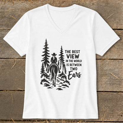 A white V-neck t-shirt with a black graphic of a horse rider in the forest and the text THE BEST VIEW IN THE WORLD IS BETWEEN TWO Ears.