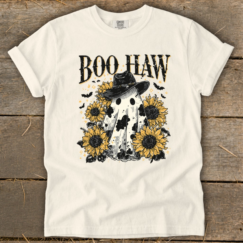 White t-shirt with "Boo Haw" text, a cow-patterned ghost wearing a cowboy hat, and sunflowers.
