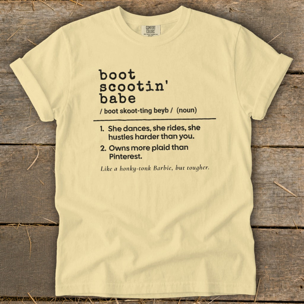 Light yellow t-shirt with black text defining "boot scootin' babe".