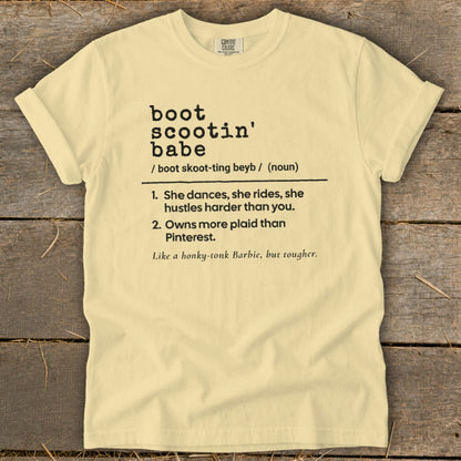Light yellow t-shirt with black text defining "boot scootin' babe".