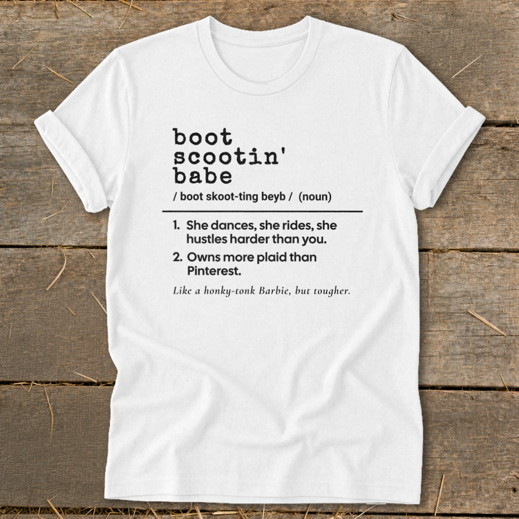 White t-shirt with "boot scootin' babe" definition and related phrases in black text.