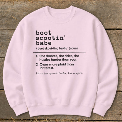 Pink crewneck sweatshirt with "boot scootin' babe" definition printed on it.