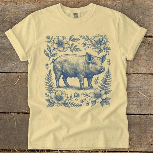 Yellow t-shirt with blue vintage pig and floral sketch graphic.