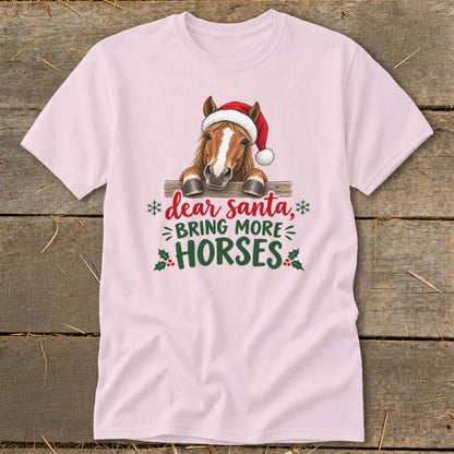 Light pink t-shirt featuring a horse wearing a Santa hat and text that reads Dear Santa Bring More Horses.