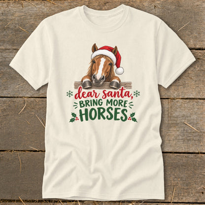 Cream t-shirt featuring a horse wearing a Santa hat behind a fence, with the text Dear Santa, Bring More Horses.