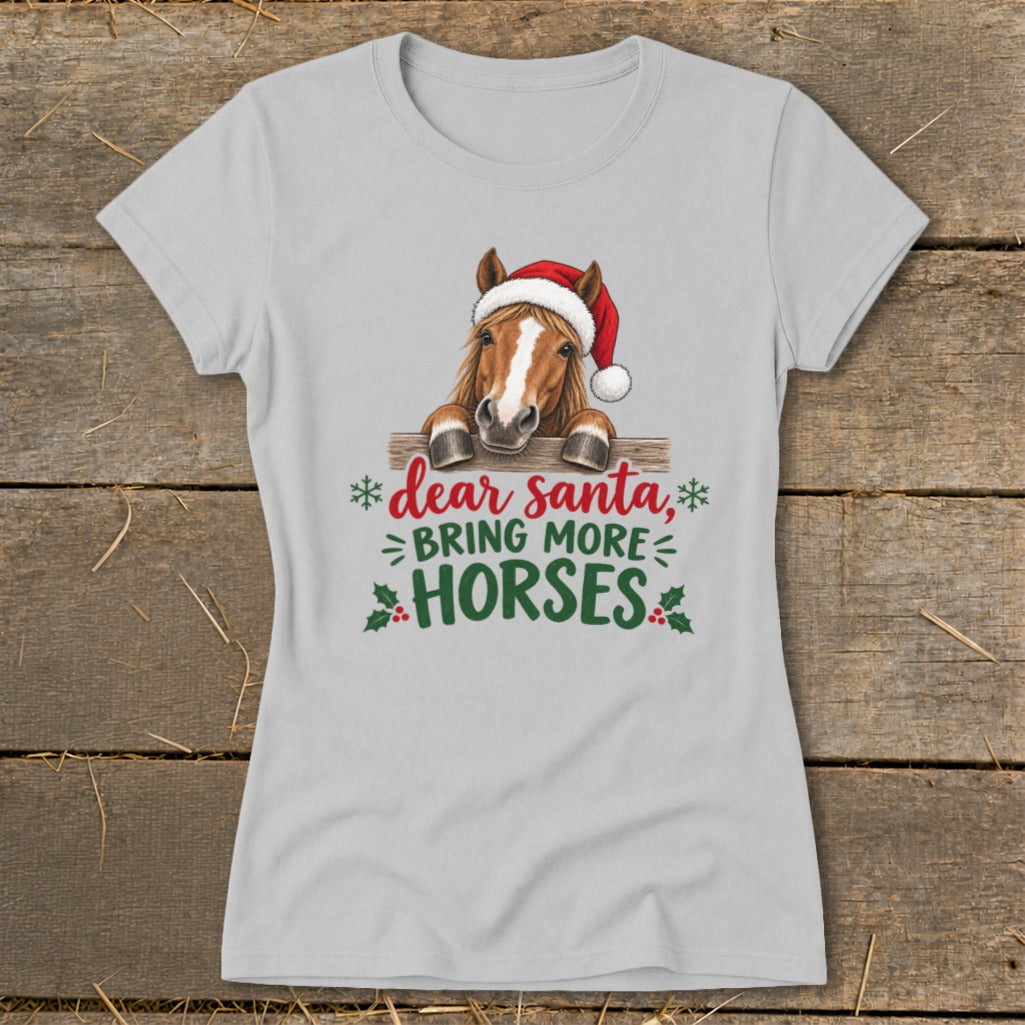 Light gray women's t-shirt featuring a horse wearing a Santa hat and the text "dear santa, BRING MORE HORSES".