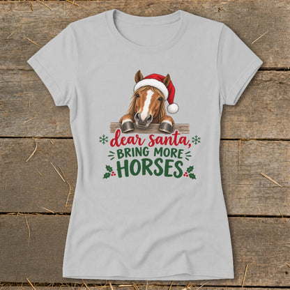 Light gray women's t-shirt featuring a horse wearing a Santa hat and the text "dear santa, BRING MORE HORSES".