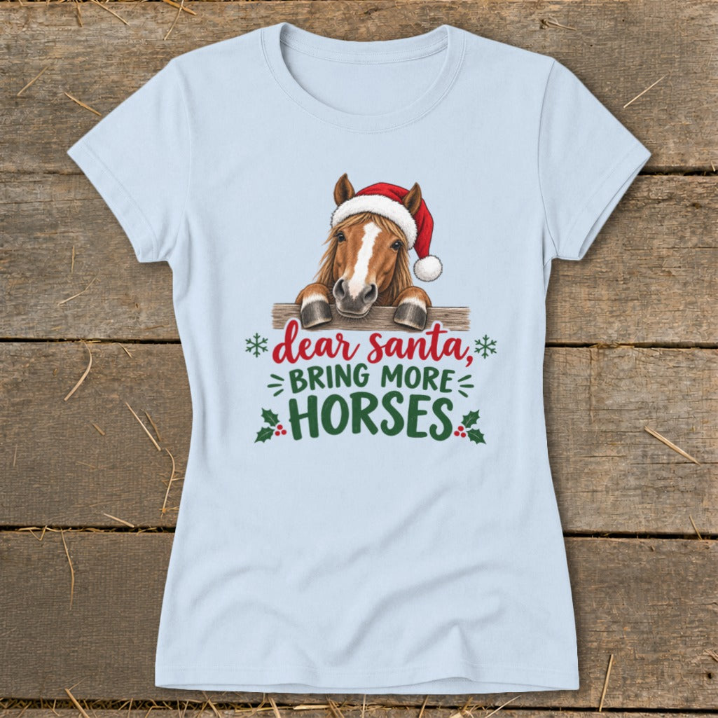Light blue t-shirt featuring a horse in a Santa hat behind a fence with holiday text.