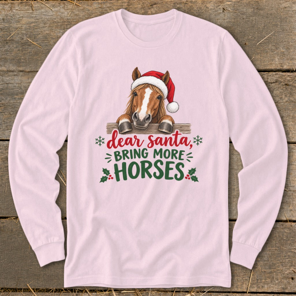 Light pink long-sleeved shirt with a horse wearing a Santa hat and text reading dear santa bring more horses.