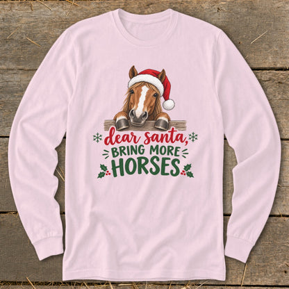 Light pink long-sleeved shirt with a horse wearing a Santa hat and text reading dear santa bring more horses.