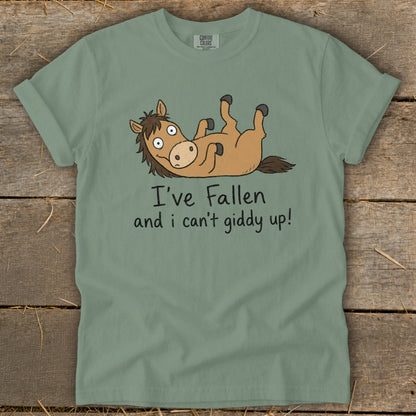 Sage green t-shirt with cartoon horse and text "I've Fallen and I can't giddy up!".