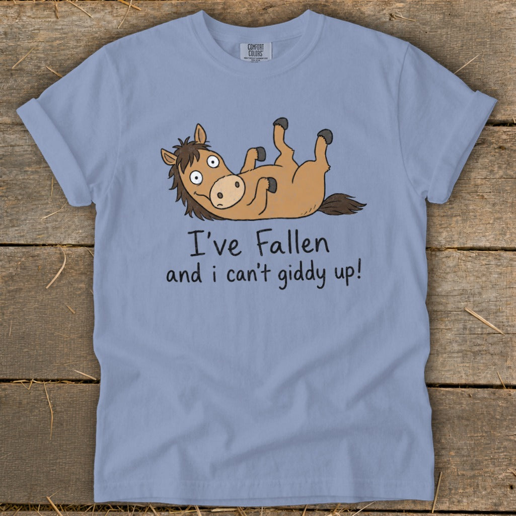 Light blue t-shirt with cartoon horse lying on its back with text "I've Fallen and I can't giddy up!"