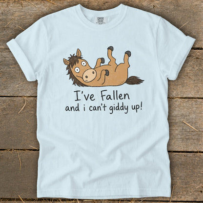 Light blue t-shirt with a cartoon horse lying on its back and text "I've Fallen and i can't giddy up!".
