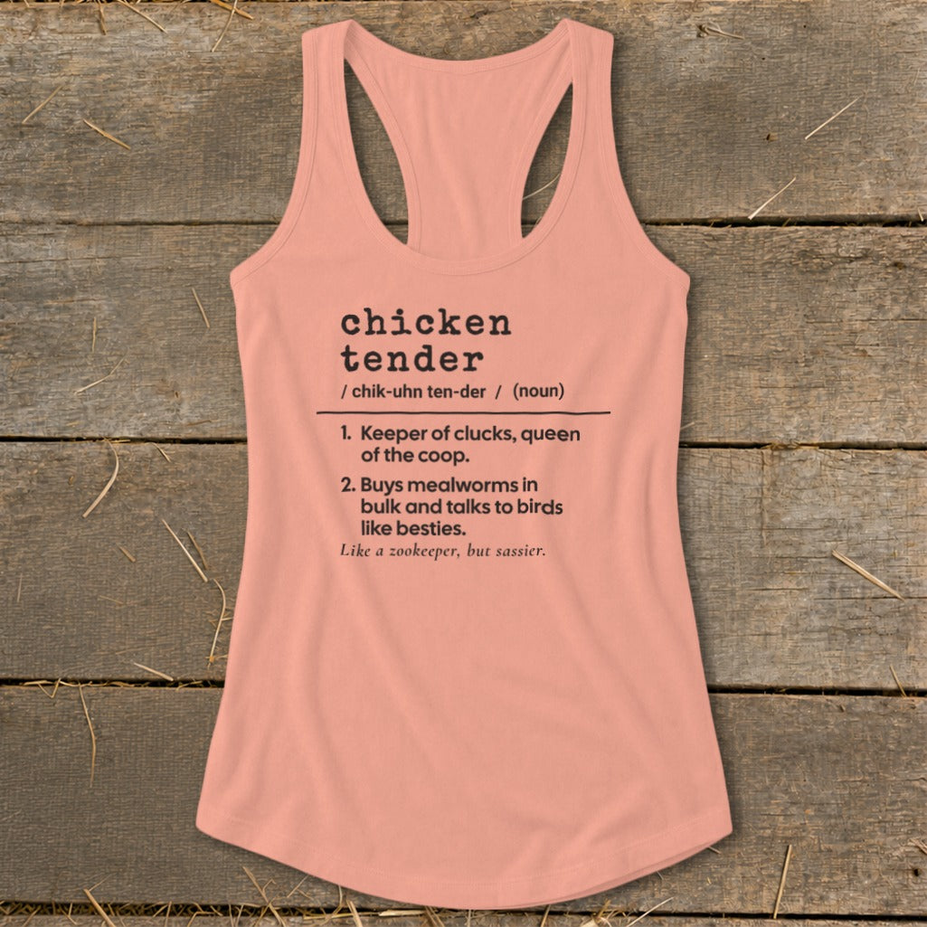 A peach-colored racerback tank top rests flat against a rustic wooden background with printed chicken tender dictionary definition text.