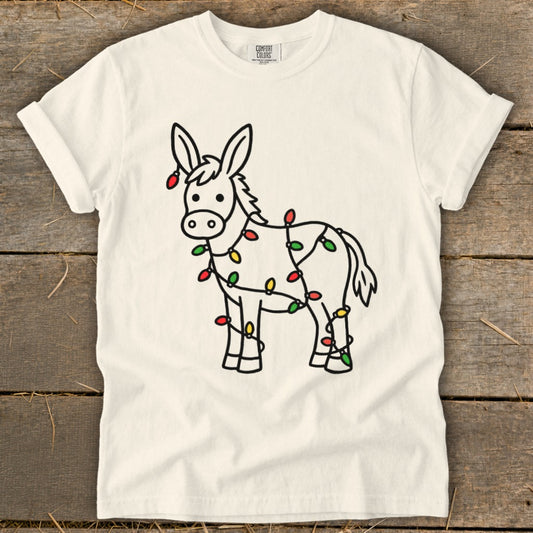 Donkey adorned with colorful Christmas lights, Comfort Colors shirt.
