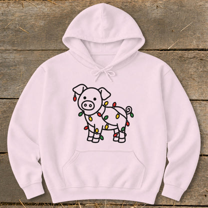 A light pink hooded sweatshirt with a cute pig graphic wrapped in Christmas lights.