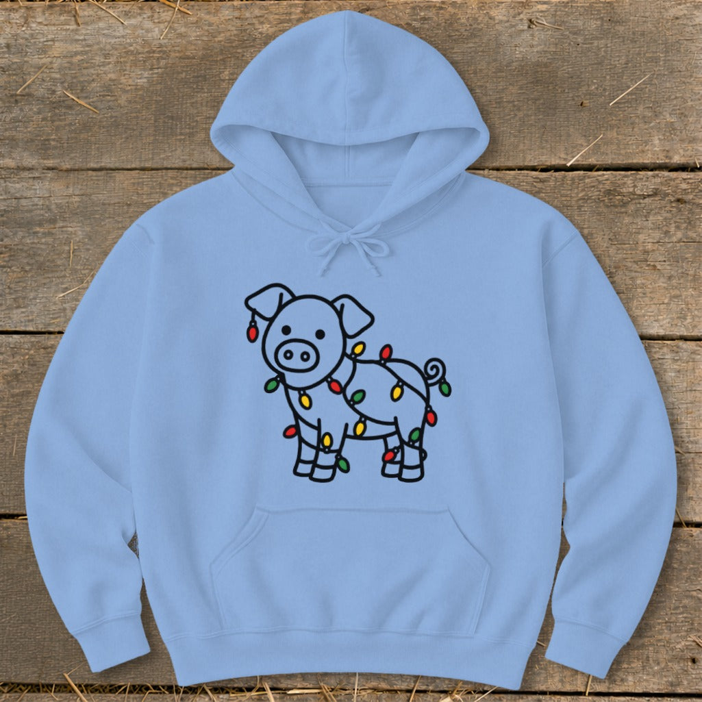 A light blue hooded sweatshirt features a black outline graphic of a pig wrapped in colorful Christmas lights.