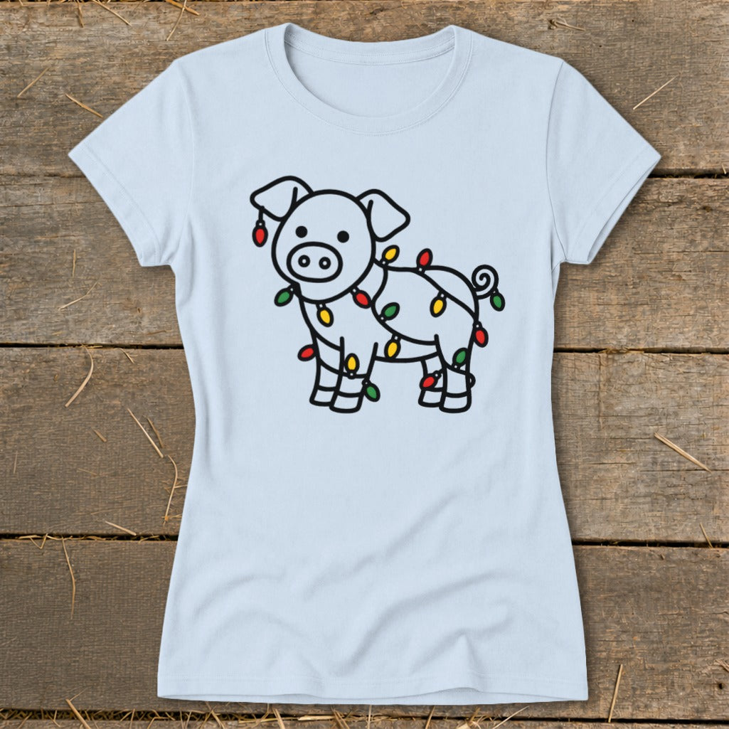 Light blue t-shirt featuring a line drawing of a pig tangled in colorful Christmas lights.