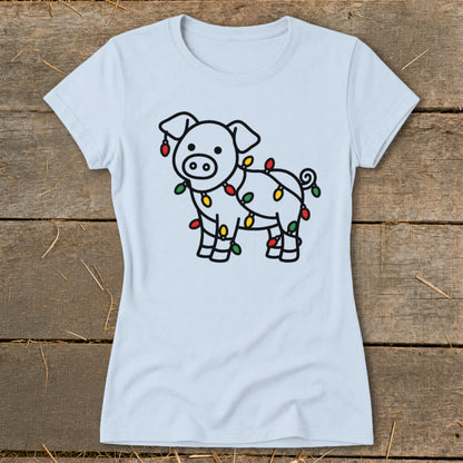 Light blue t-shirt featuring a line drawing of a pig tangled in colorful Christmas lights.