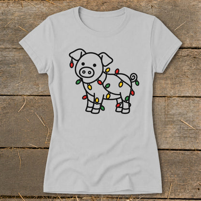 A light gray crewneck t-shirt featuring a line drawing of a pig wrapped in colorful Christmas lights.