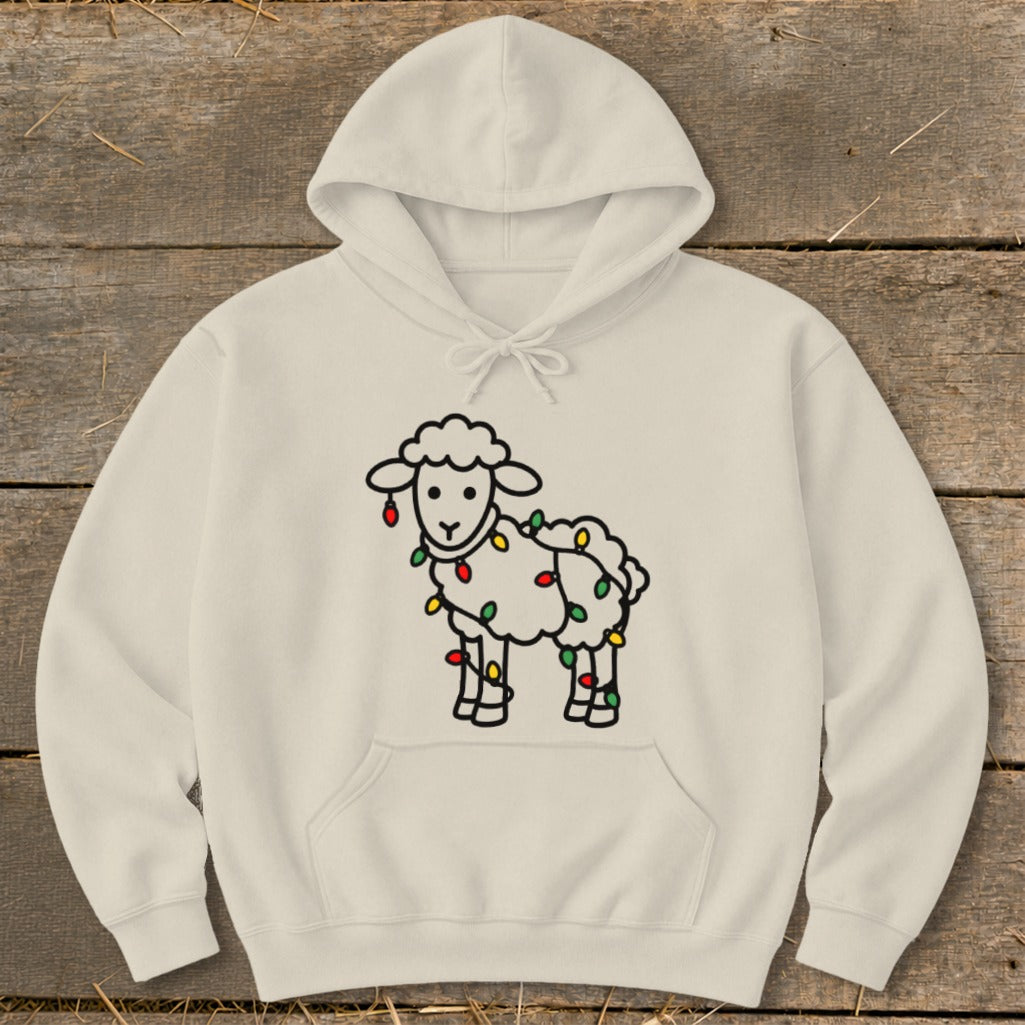 A cream-colored hoodie features a graphic of a white sheep wrapped in colorful holiday lights.