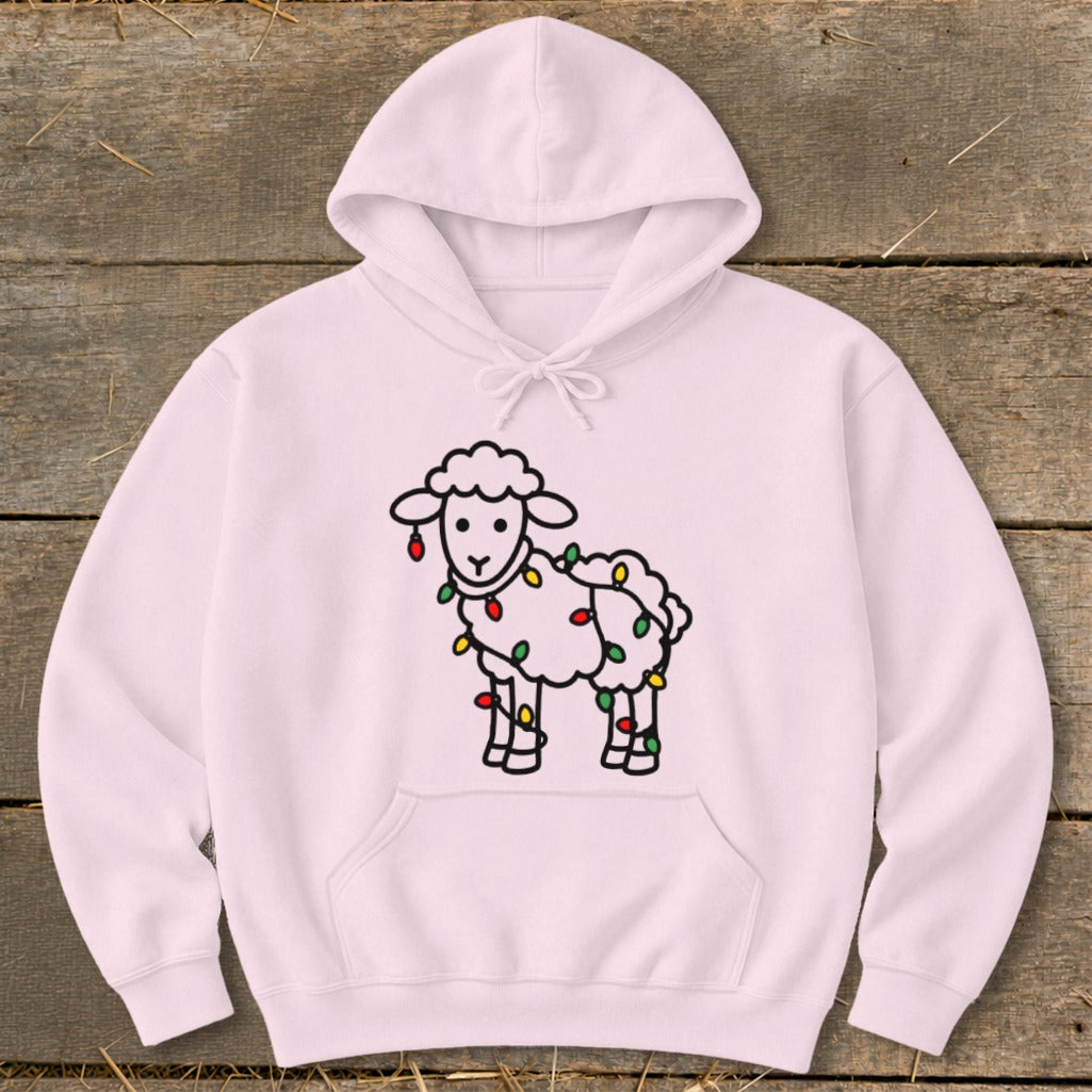A light pink hooded sweatshirt with a cute sheep graphic tangled in colorful Christmas lights.