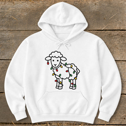 A white hooded sweatshirt features a cartoon illustration of a cute sheep wrapped in colorful holiday lights.