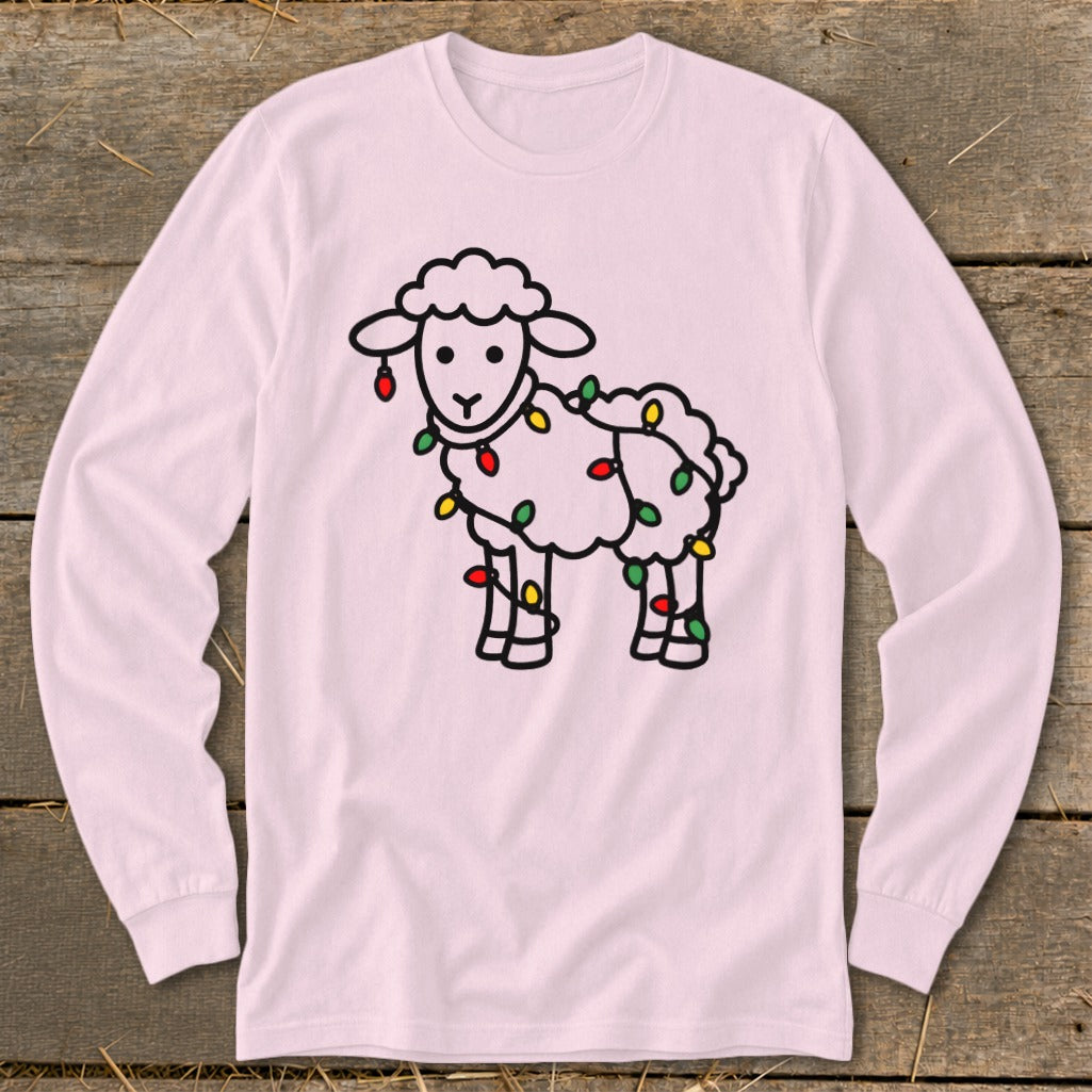 A light pink long-sleeve shirt featuring a cartoon sheep tangled in colorful Christmas lights.