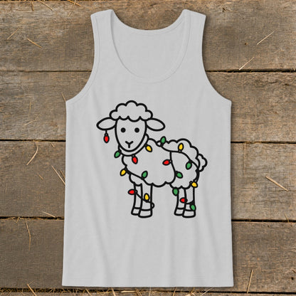 A light gray tank top with a cartoon sheep tangled in colorful Christmas lights, displayed on a wooden surface.