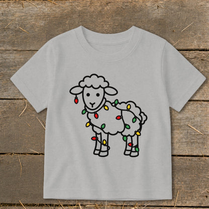 A light gray short-sleeved child's t-shirt printed with a cartoon sheep wrapped in colorful holiday lights.