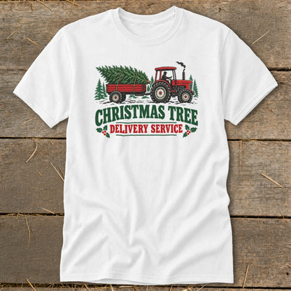 White t-shirt with a red tractor towing a trailer with a Christmas tree, reads "Christmas Tree Delivery Service".