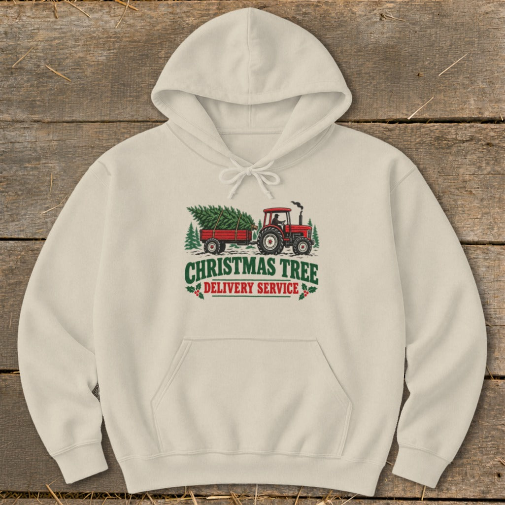Red tractor pulling a trailer with a Christmas tree, text reads "CHRISTMAS TREE DELIVERY SERVICE".
