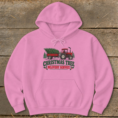Pink hoodie with "Christmas Tree Delivery Service" graphic of a tractor and trailer.
