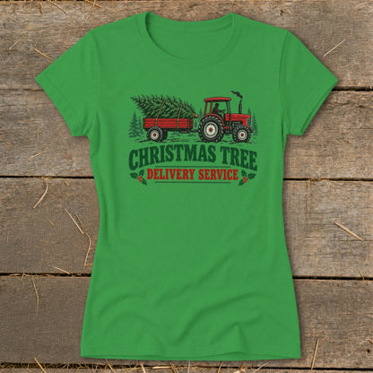 Green t-shirt graphic of a red tractor pulling a trailer with Christmas trees, text reads "Christmas Tree Delivery Service".