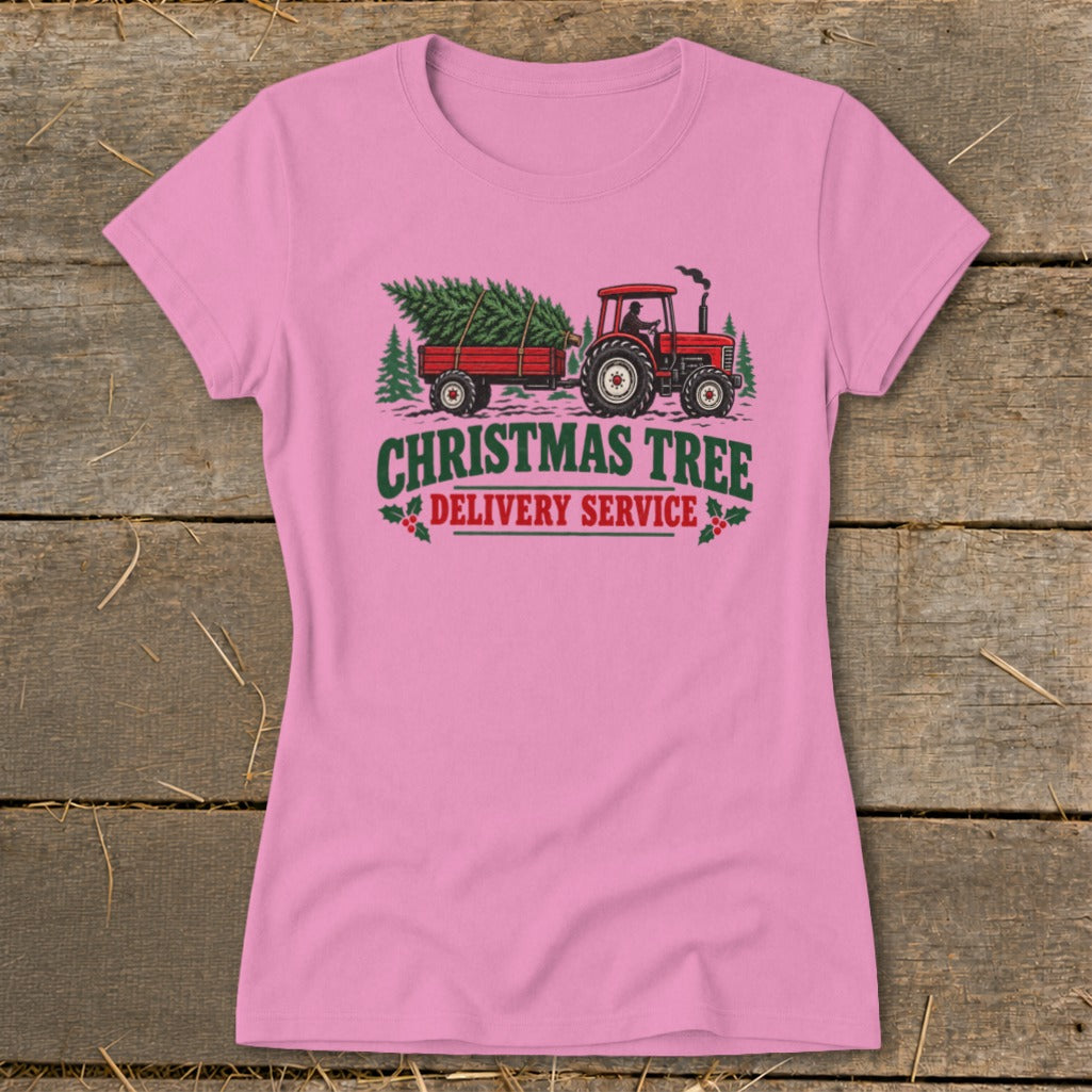 Pink t-shirt with red tractor pulling a Christmas tree trailer and text.
